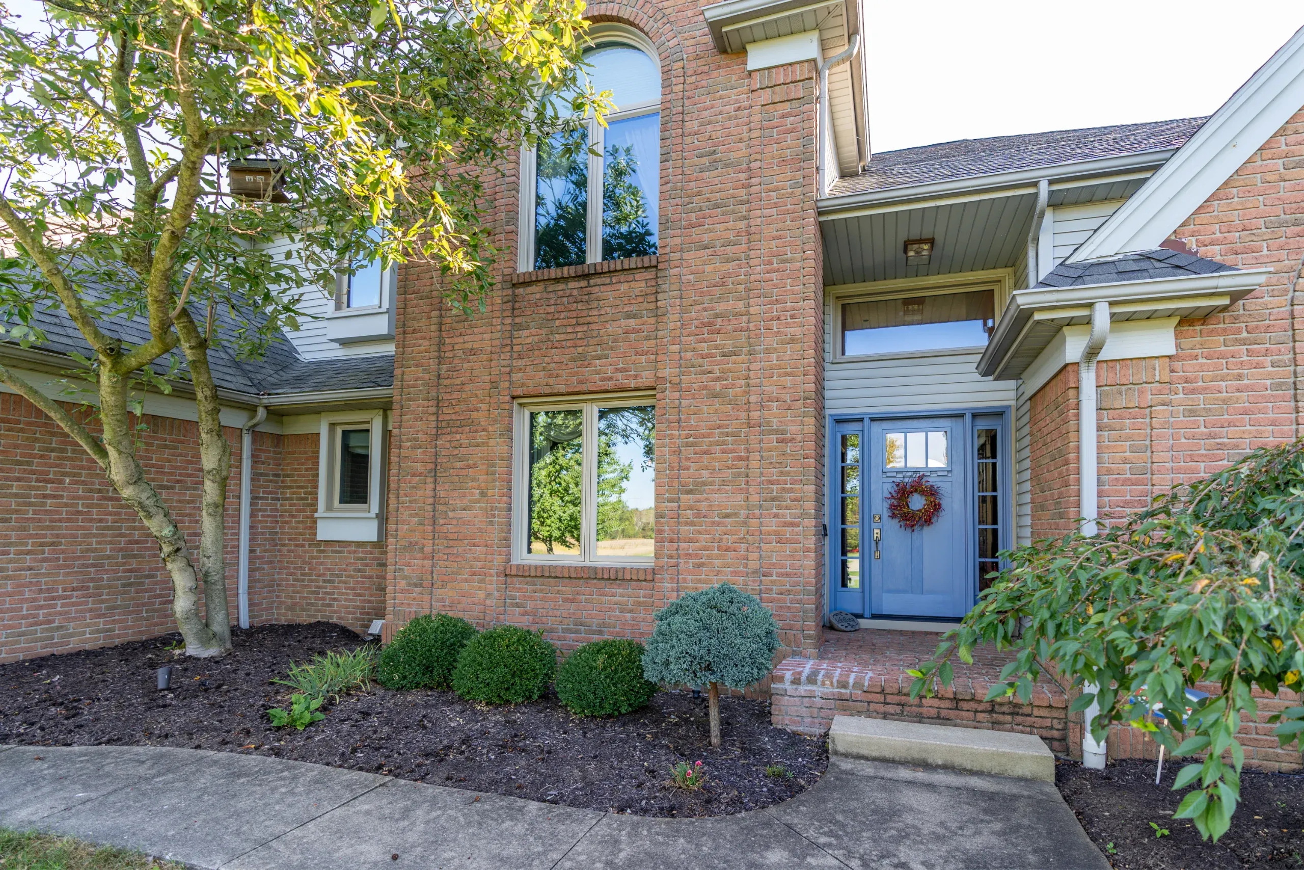 Replacement windows on a brick home exterior in Toledo