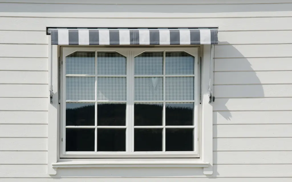 Exterior view of a newly installed awning window with a protective awning above it in Toledo, Ohio.