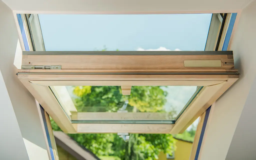Close-up of an open awning window mechanism during a professional service call in Toledo, Ohio.