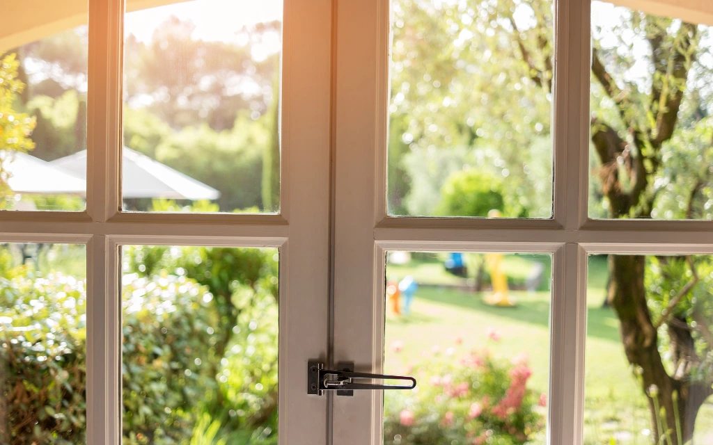 Professional casement window inspection in a Toledo, Ohio home, checking operational hardware and secure latches.