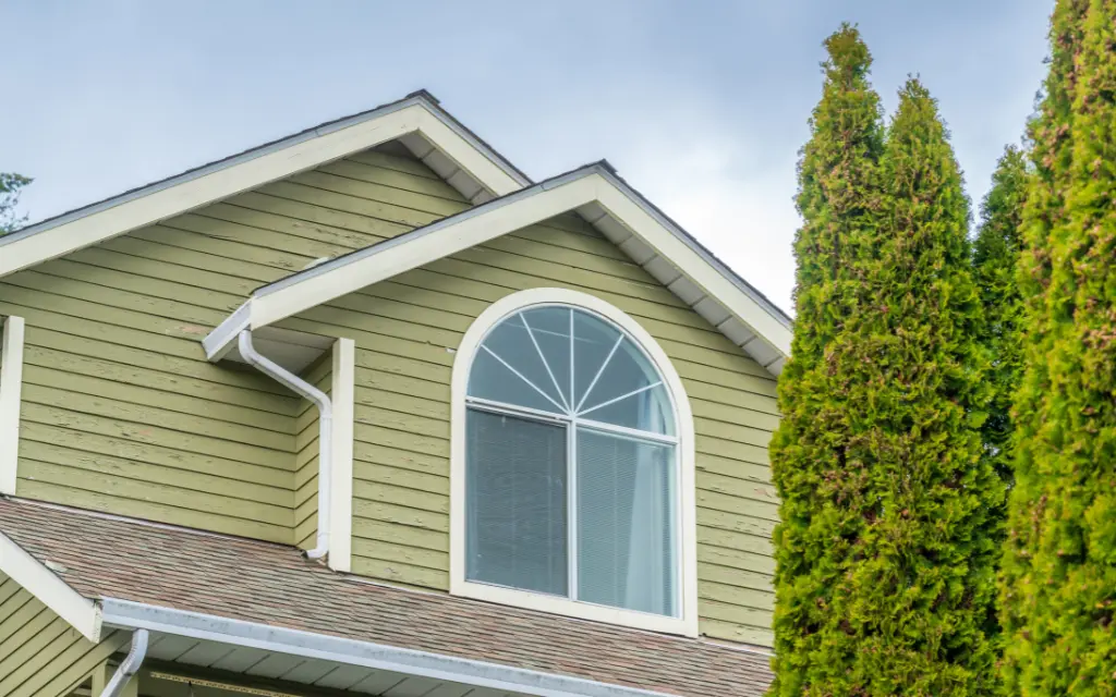 Large half-circle custom shape window replacement installed on a green gable home in Toledo, Ohio.